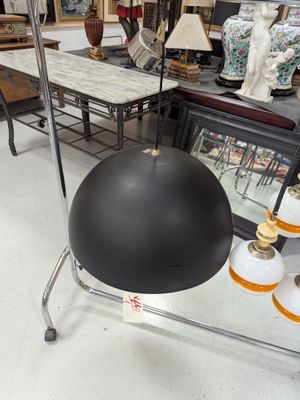 a black ball on a metal stand in a store