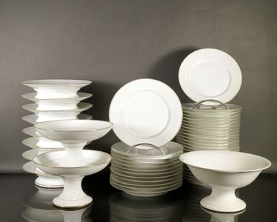 a lot of plates and bowls on the table