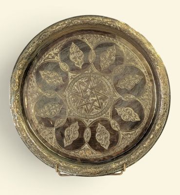 a silver tray with a decorative design on it