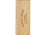 a wooden box with a bottle of wine in it on a white surface