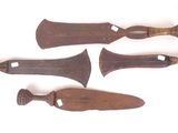 three old wooden knives are sitting on a white surface