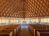 an image of a large church with wooden pews