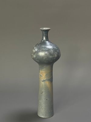 a gray vase that is sitting on a table