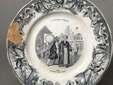 an old plate with a picture of a man and a woman on it