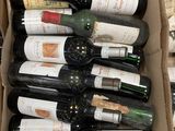 bottles of wine are in a cardboard box on a table