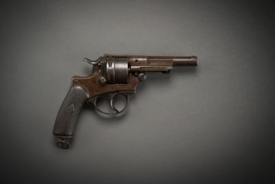 an old revolver on a gray surface with a black background