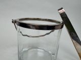 a glass container with a metal lid and a spoon in it