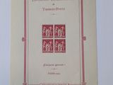 a close up of a book on a white surface with a red border