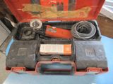 a red tool case with tools in it on a table