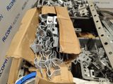 a pile of metal parts in a cardboard box