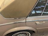 a brown car with a tan cover on the back of it
