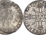 a silver coin with an image of a woman and a cross on it