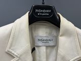 an image of a white jacket hanging on a hanger