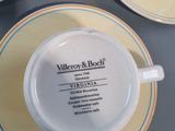 a cup and saucer sitting on a table next to a plate
