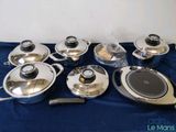 a lot of pots and pans on the table