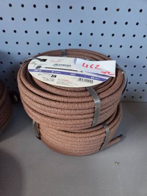 several rolls of rope on a shelf in a store