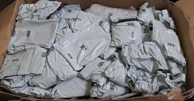 a cardboard box full of clothes that are sitting on the floor