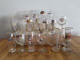 a lot of wine glasses sitting on a wooden table