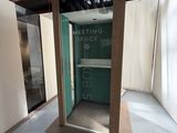 une porte vitrée au milieu d'une pièce, sur laquelle est accrochée une pancarte