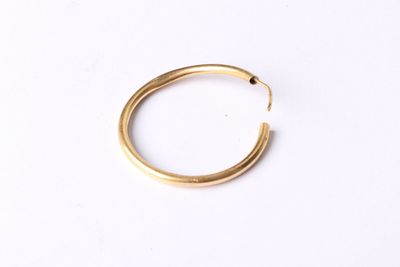 a gold ring on a white background