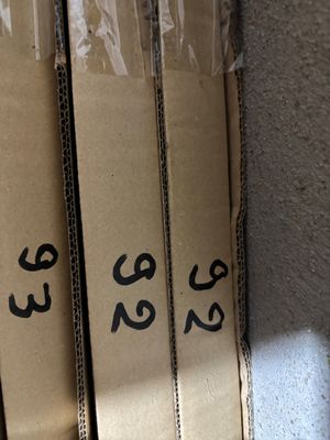 three boxes with numbers on them sitting on a shelf