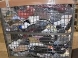 a metal cart with many items in it in a warehouse