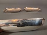 a silver spoon with a handle on a table