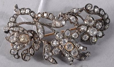 a silver brooch with a bunch of diamonds on it