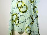 an image of a green and yellow scarf on a mannequin