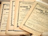 several old books are stacked on top of each other on a table