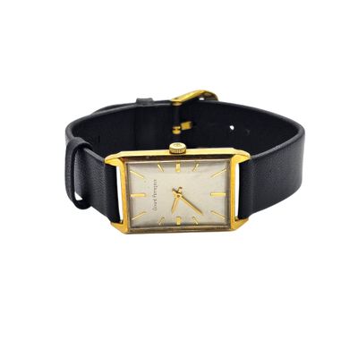 a close up of a watch on a black leather strap