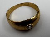 an image of a gold ring with a diamond in the middle