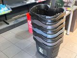 a black trash can sitting on the floor in a store