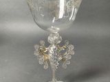 a wine glass with a gold decoration on it