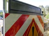 a red and white sign that is on the side of the road