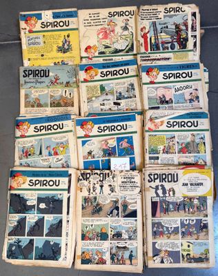 several old comic books are stacked on top of each other