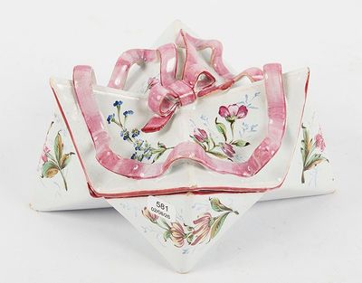 a white plate with a pink bow on top of it