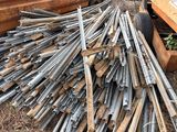 a large pile of metal rods in the back of a truck