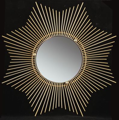 a gold sunburst mirror on a black background
