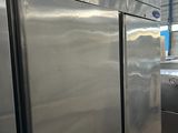 stainless steel refrigerators are lined up in a large industrial kitchen