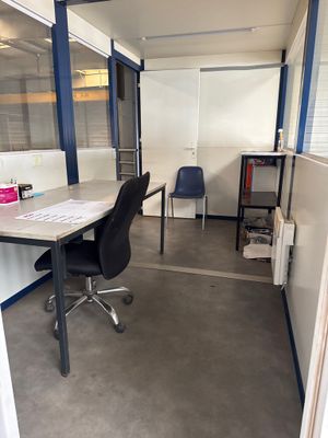 a room with a desk and a chair in it