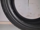 tire tread of a motorcycle on a white floor in a garage