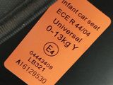 an orange tag on the back of a luggage bag