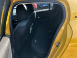 a yellow car with its door open and a black seat