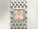 an image of a close up of a wrist watch on a white surface