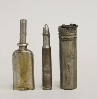 three old metal bottles are lined up next to each other