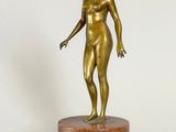 bronze statue of a woman standing on a marble base