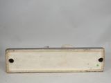 an old metal box with a hole in it on a white surface