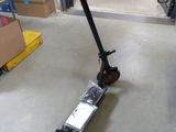 a scooter that is sitting on the floor in the garage