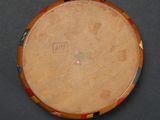 a close up of a drum on a table with a black background